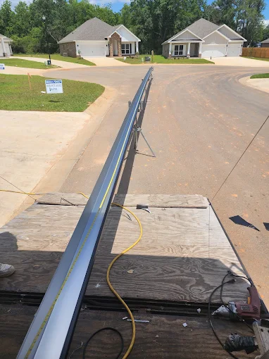 Close view down a long seamless gutter run during installation.